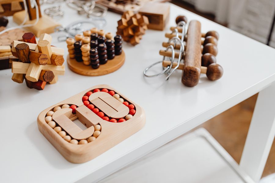 A collection of wooden brain-teaser puzzles arranged on a table.